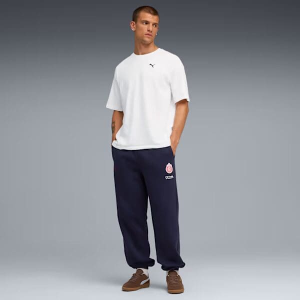 Man in casual white shirt and joggers.