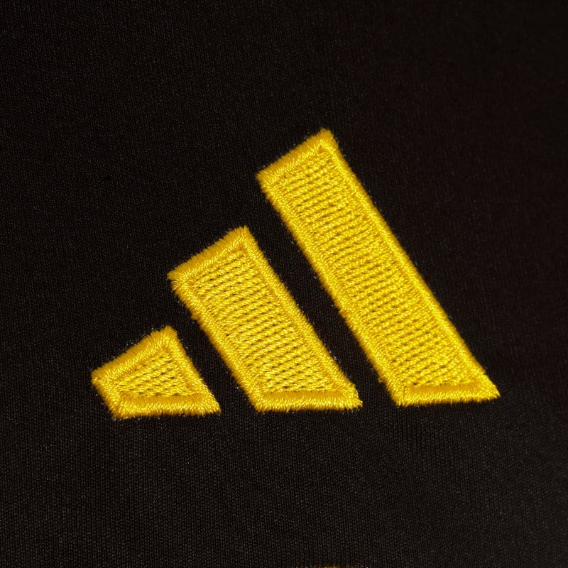 Yellow embroidered logo on black fabric background.