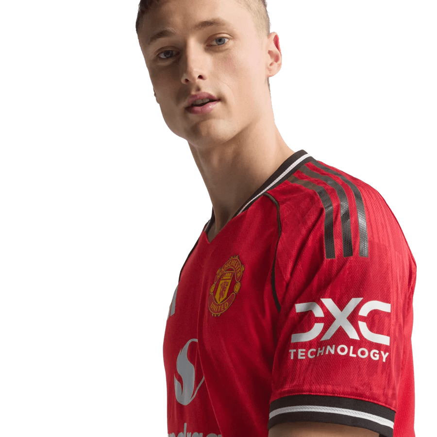 Person in red Manchester United soccer jersey.