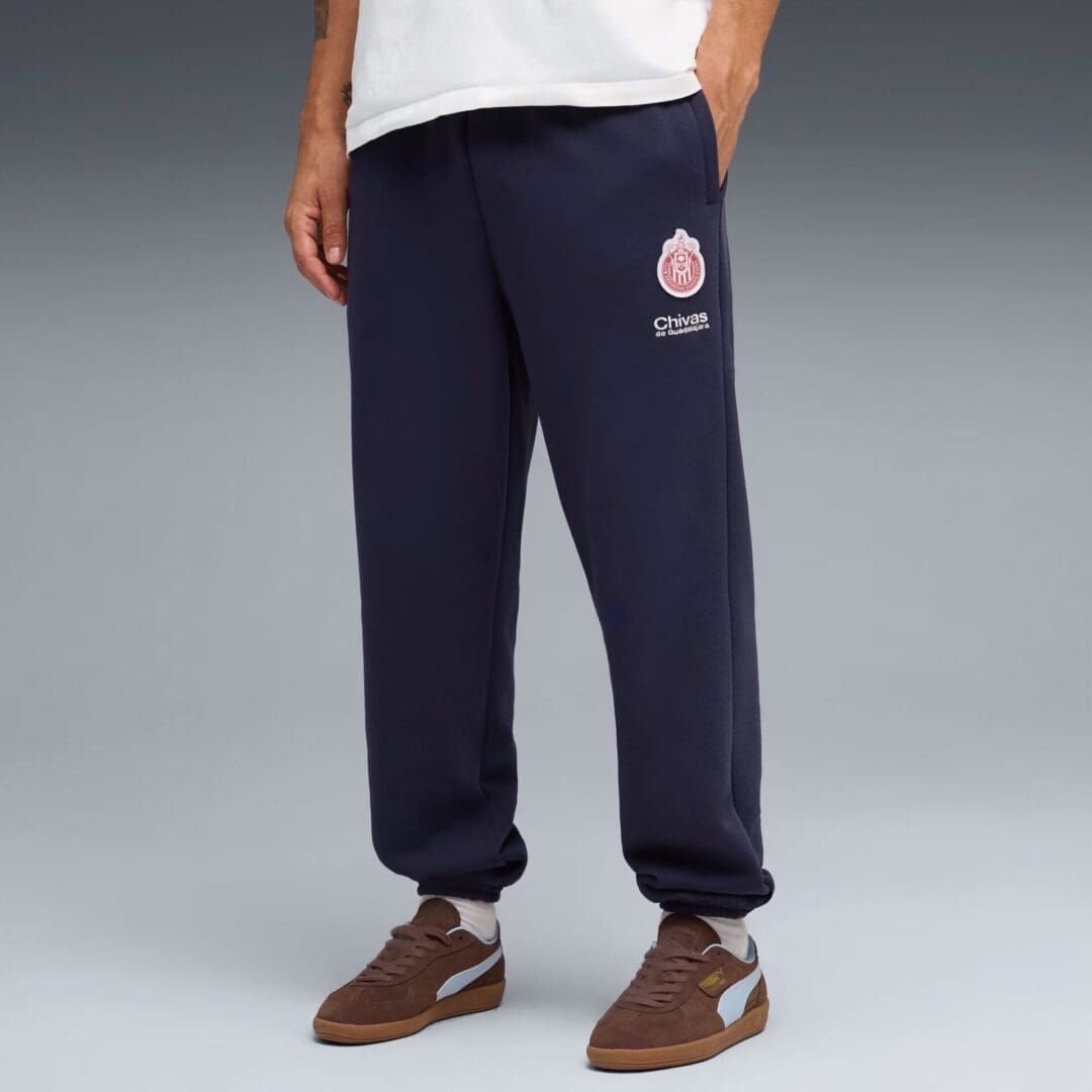 Man wearing navy sweatpants and brown sneakers.